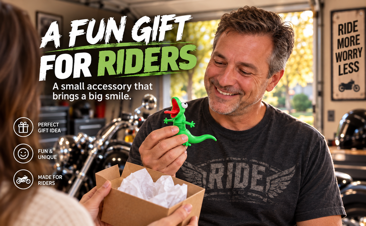Motorcycle enthusiast smiling while holding a funny green wobble lizard figurine received as a novelty biker gift.
